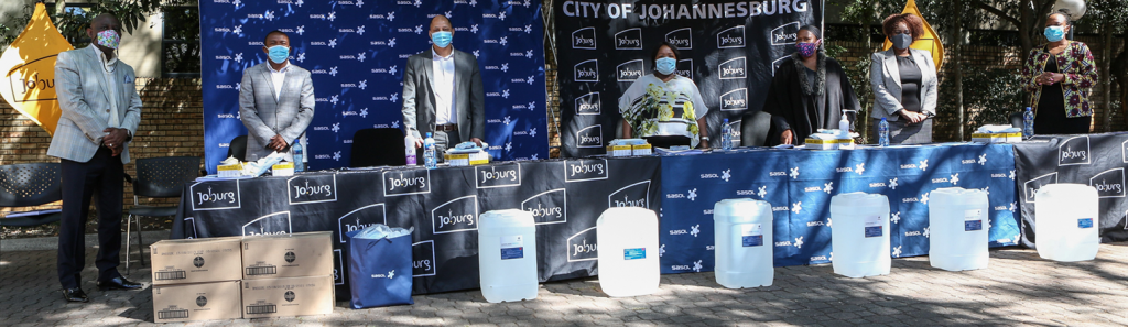 City of Joburg officials standing during the handover of COVID-19 supplies by Sasol
