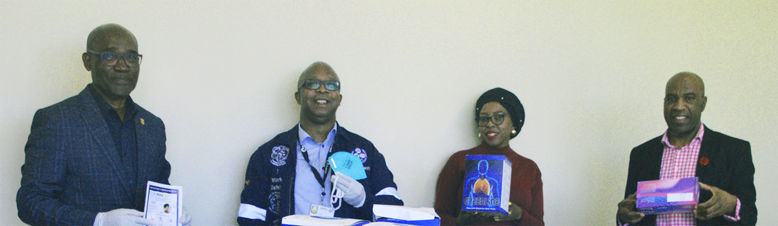 Dignitaries posing with PPE items being donated to Fezile Dabi District Department of Health to fight COVID-19